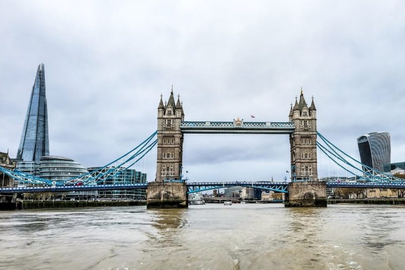 tower bridge stretched over river thames