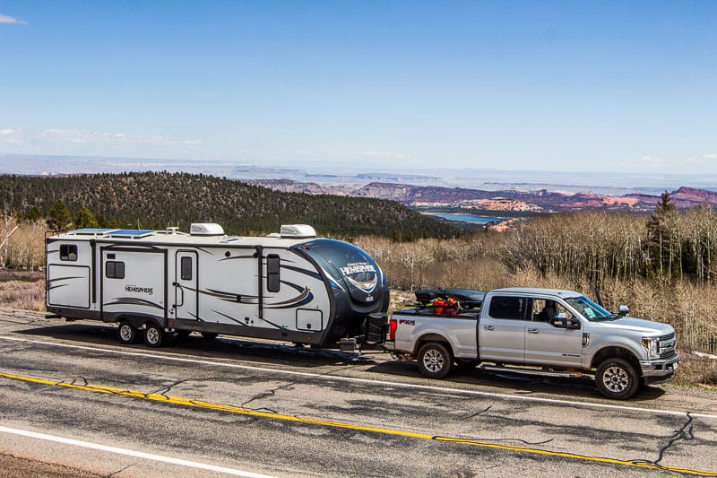 caravan and truck parked on the side of the road
