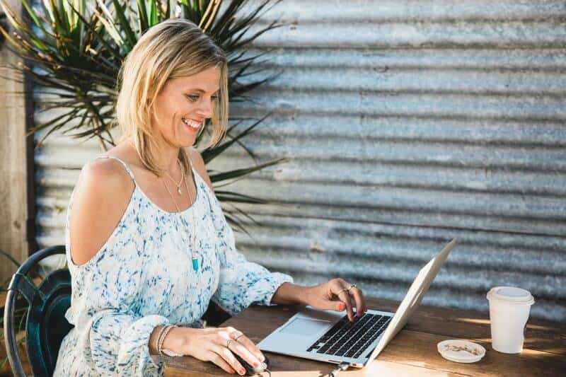 woman sitting at laptop smiling