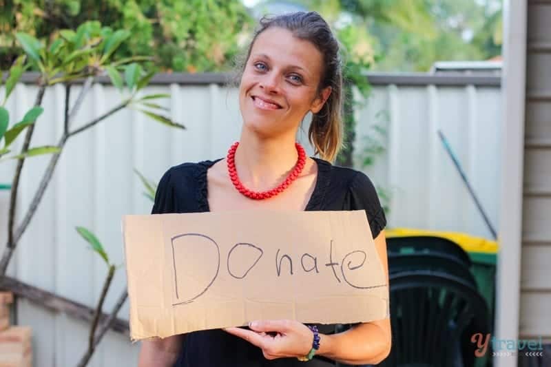 woman holding a donate sign
