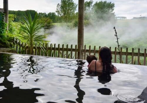 A woman and her baby inside a hot spring and spa pool in Rotorua,