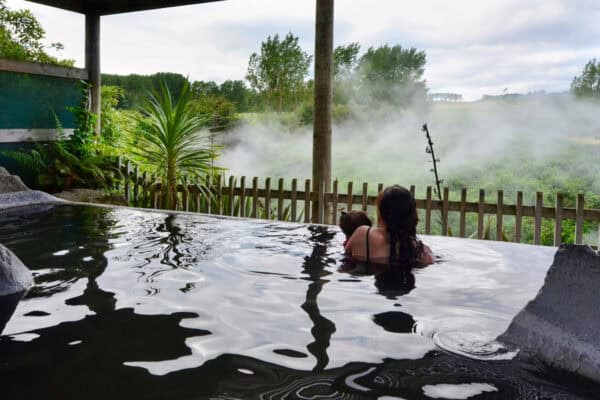 A woman and her baby inside a hot spring and spa pool in Rotorua,