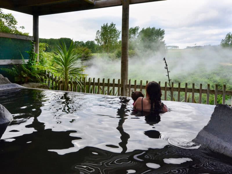 A woman and her baby inside a hot spring and spa pool in Rotorua,