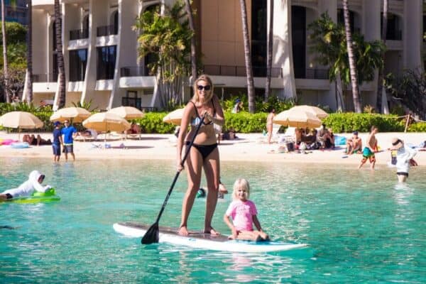 people stand up paddle boarding in the water