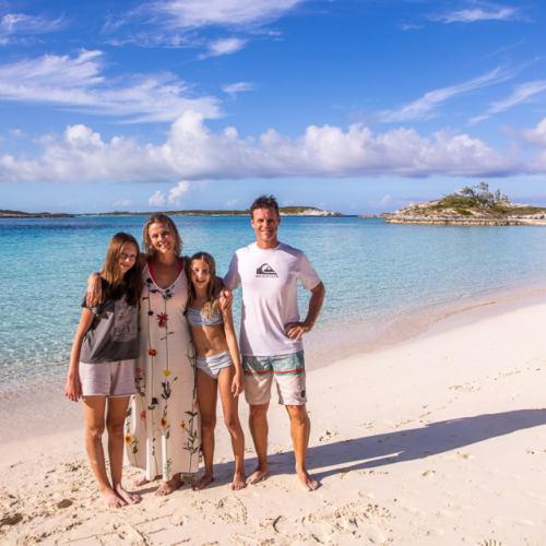 Untitled design family posing on exuma island beach
